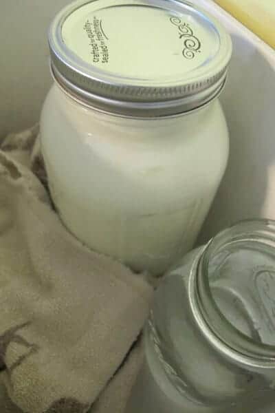 goat milk yogurt incubating in a cooler with a jar of boiling water