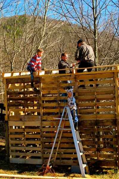 putting roof supports on pallet barn