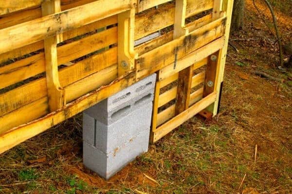 cinder block supporting the wall of the pallets