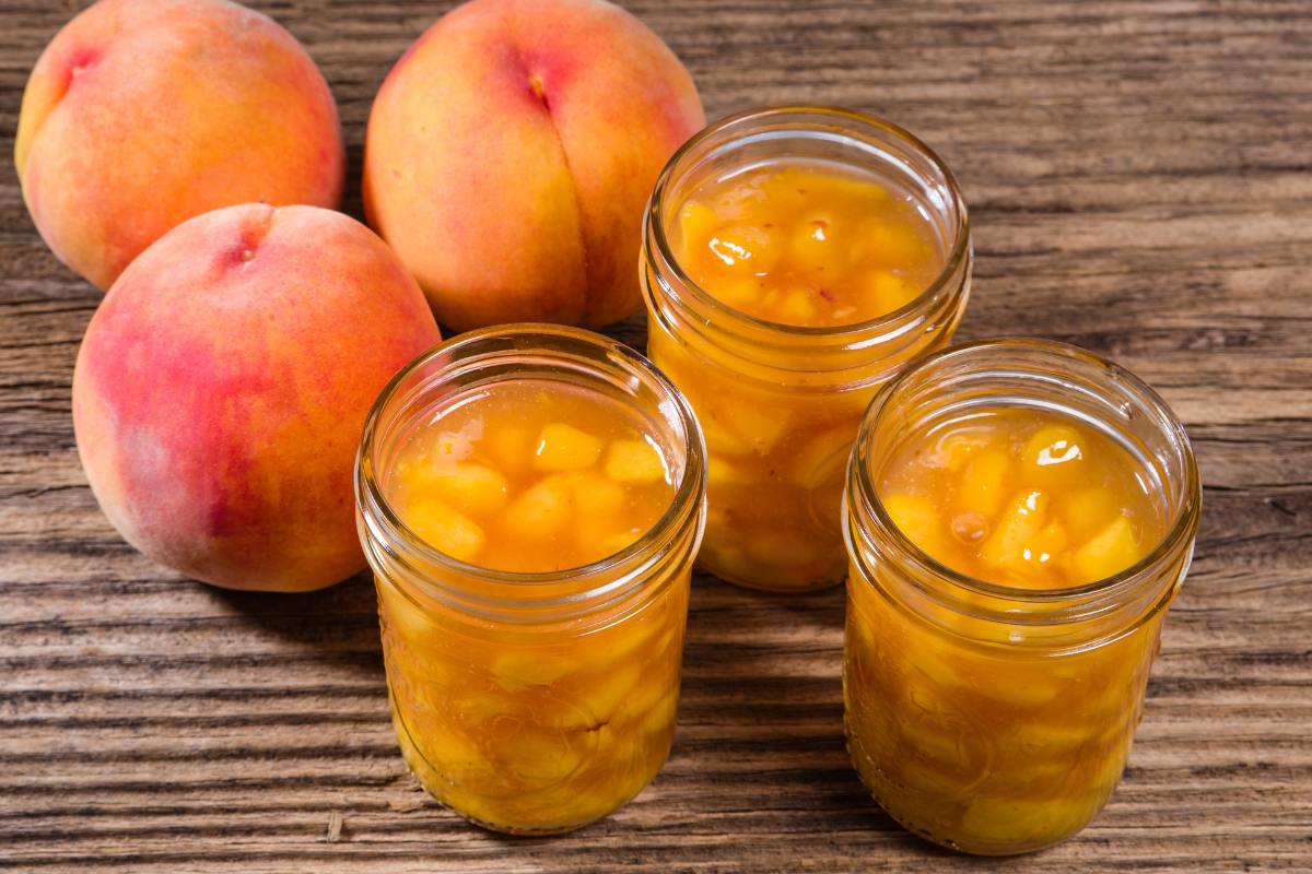 peach pie filling on table with fresh peaches