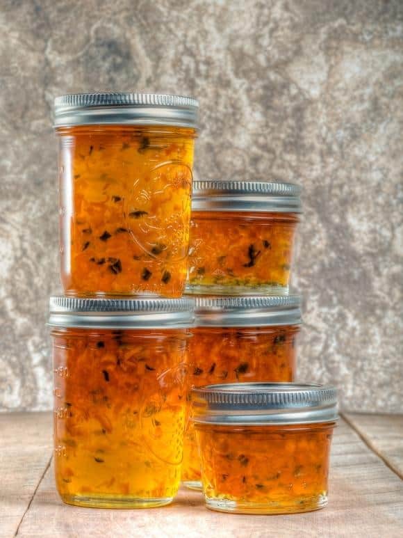 jars of orange pepper jelly on a table