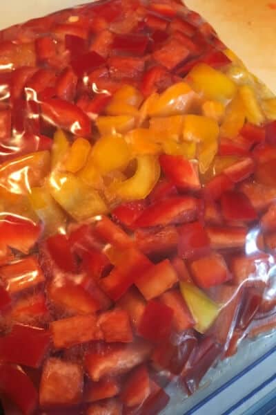 red and yellow cut peppers in a freezer bag