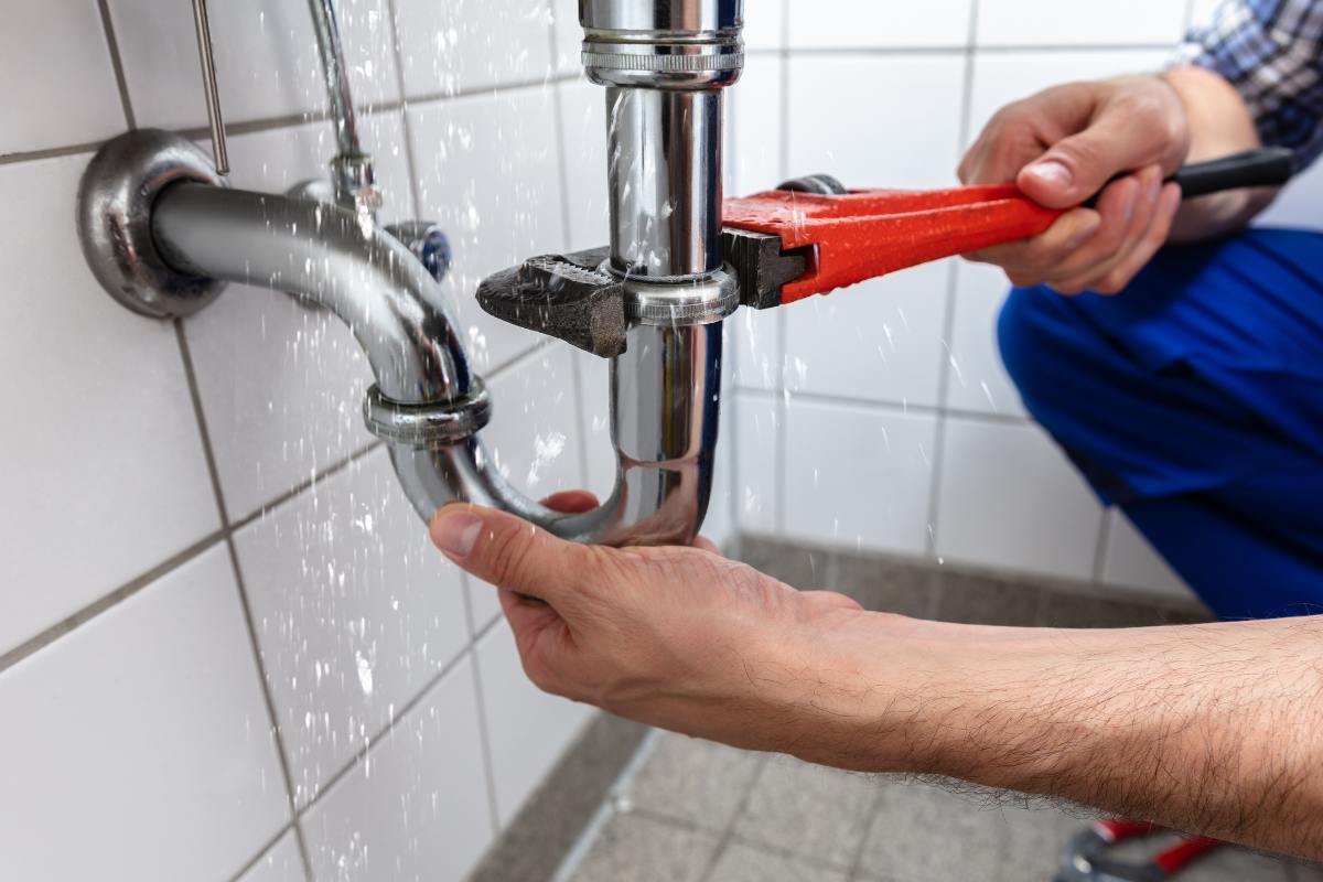 man plumbing sink at home