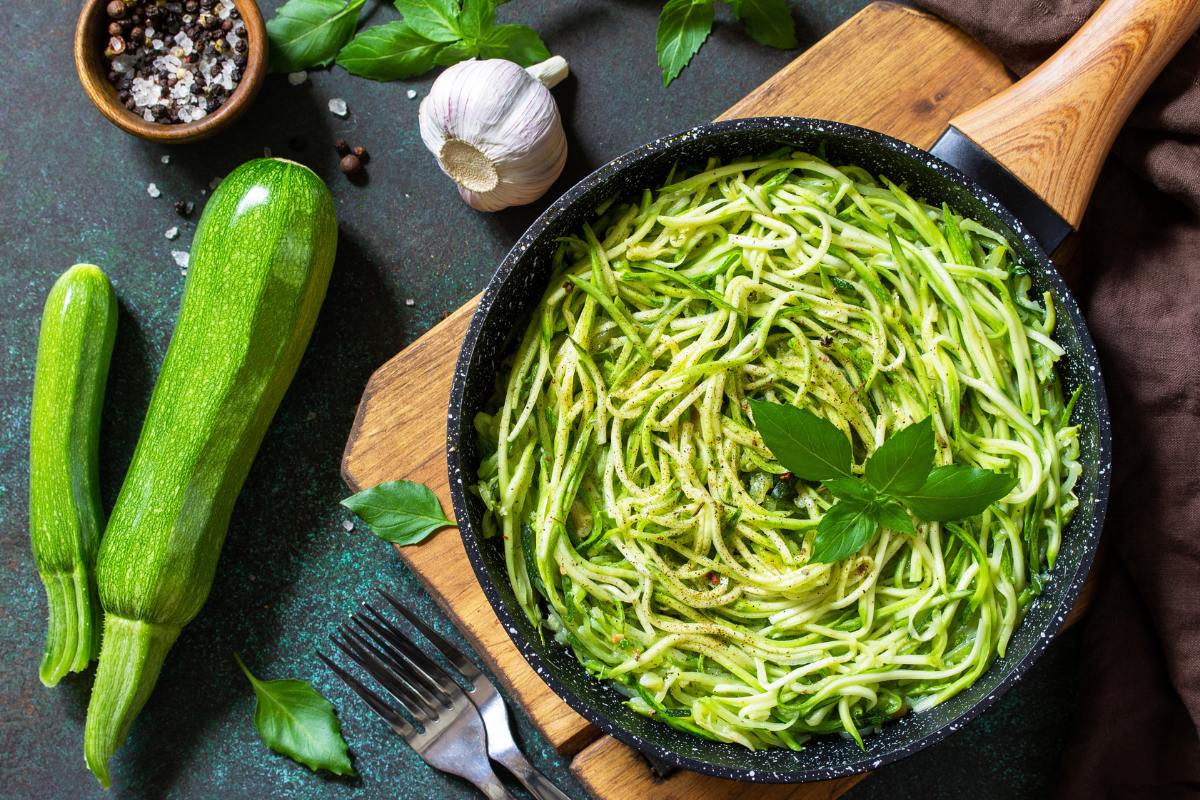 zucchini noodles on plate with fresh zucchini